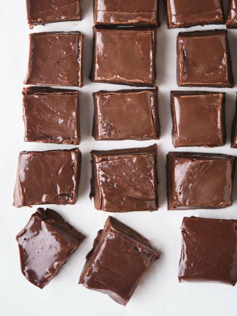 Square pieces of chocolate fudge are arranged neatly.