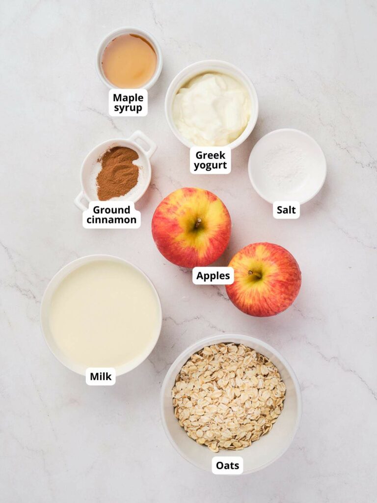 Ingredients for apple cinnamon overnight oats displayed on a surface.