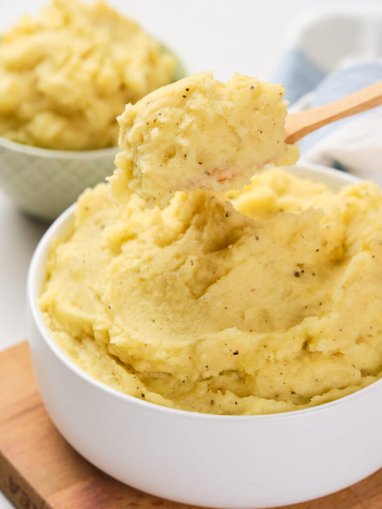 Close-up of garlic mashed potatoes in a white bowl.