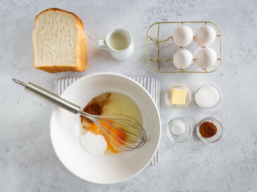 Ingredients for making French toast are laid out on a countertop.