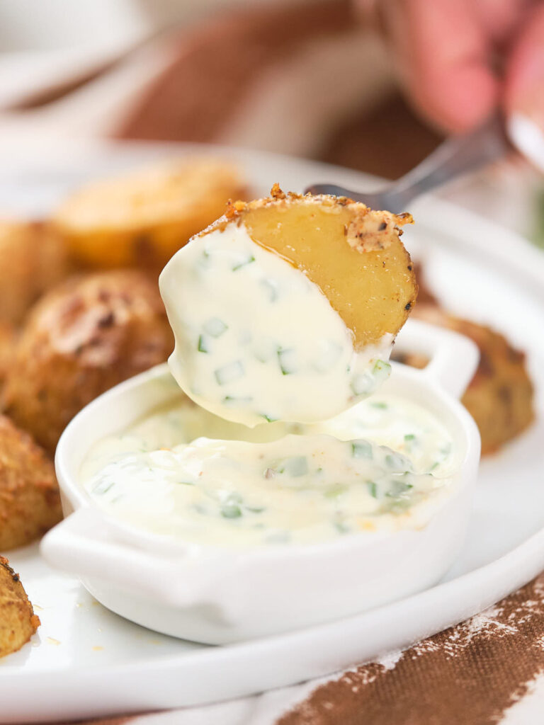 Parmesan potato dipped in creamy sauce with chopped herbs.