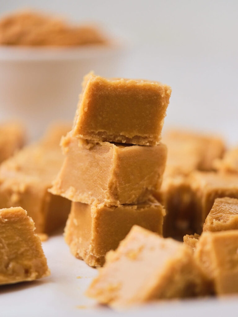 Close-up of a small stack of three pieces of peanut butter fudge.