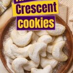 A plate of almond crescent cookies dusted with powdered sugar.