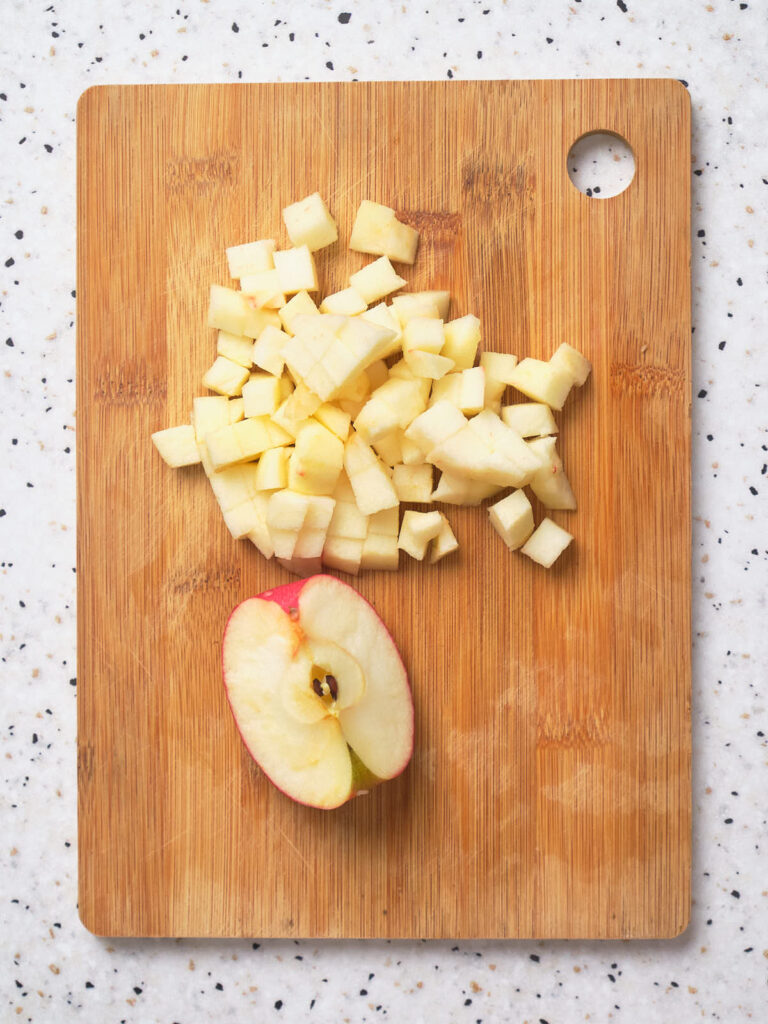 Diced apples on a wooden cutting board.