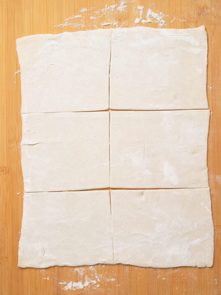 Pasty dough laying on a wooden surface.