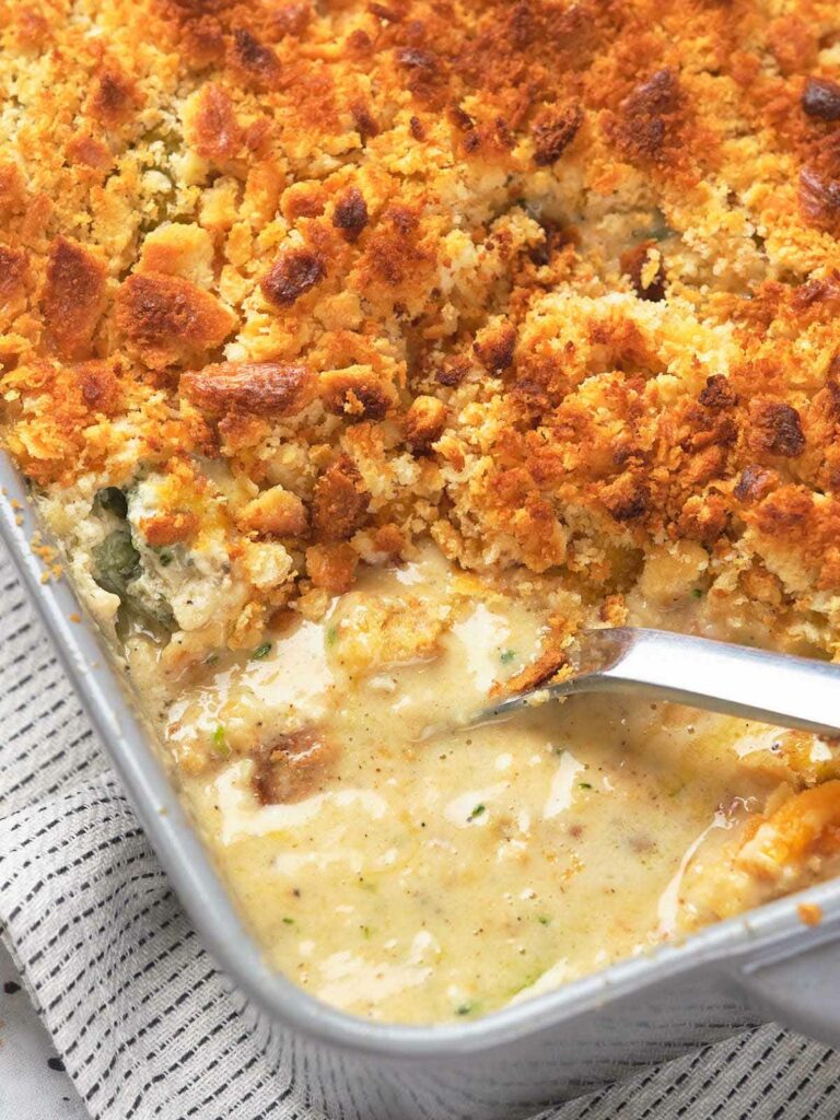 A baking dish filled with a creamy broccoli casserole topped with golden breadcrumbs.