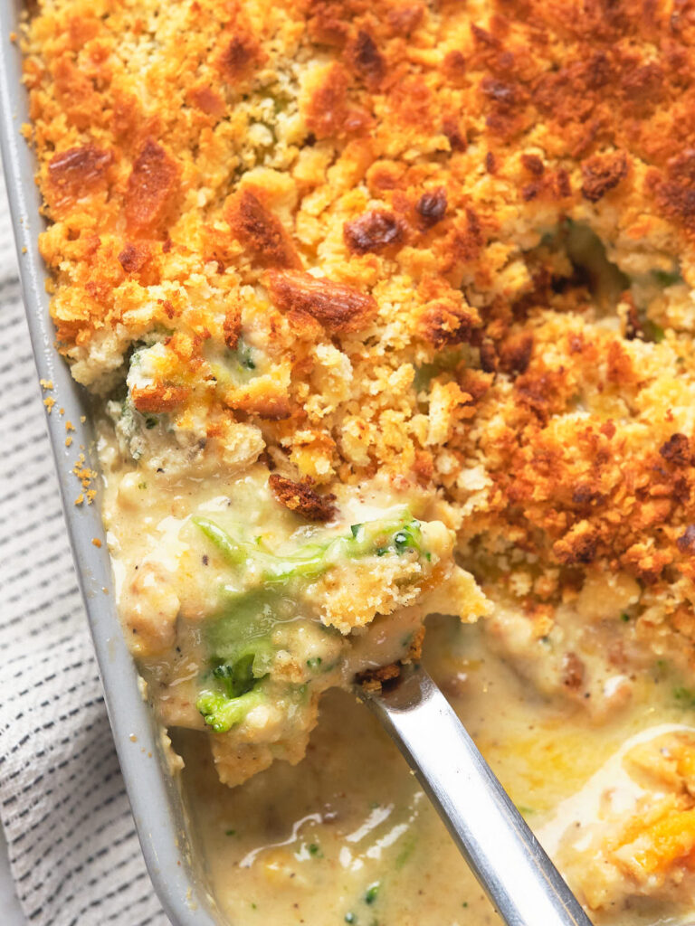 A close-up of a baked cheesy broccoli casserole with a crispy breadcrumb topping.