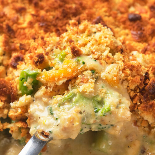 Close-up of a spoonful of creamy broccoli casserole with breadcrumbs on top.