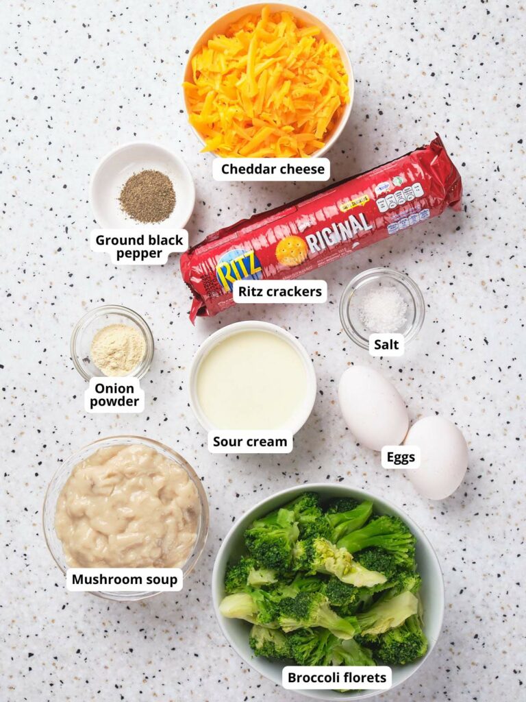 Ingredients for broccoli casserole on a speckled surface.