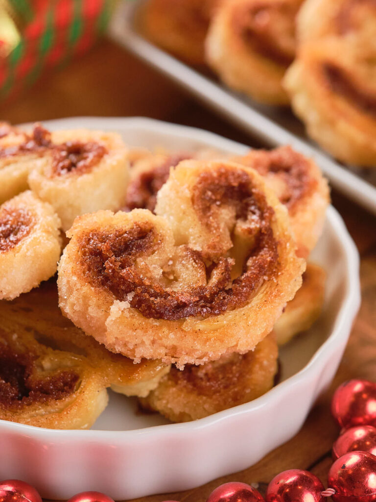 A plate of cinnamon palmiers with a golden-brown, sugar-topped crust.