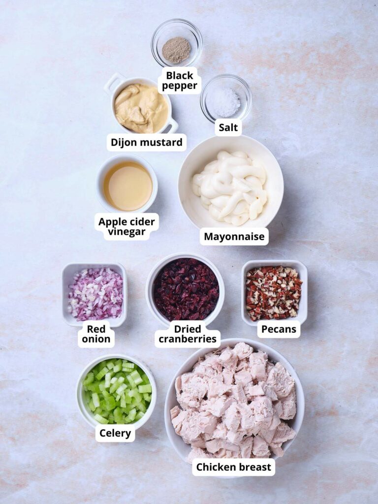 Ingredients for cranberry chicken salad laid out, each labeled accordingly.