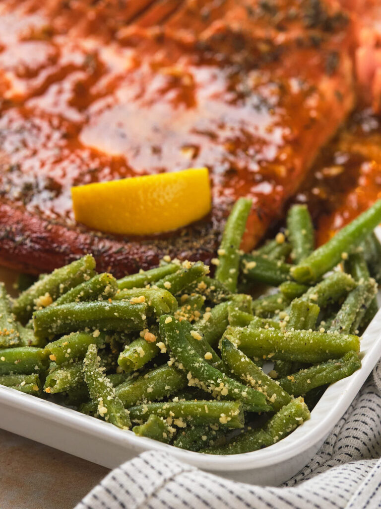 Close-up of frozen roasted green beans with grated cheese.