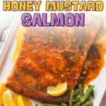 Plate of honey mustard salmon with lemon wedges and green beans.