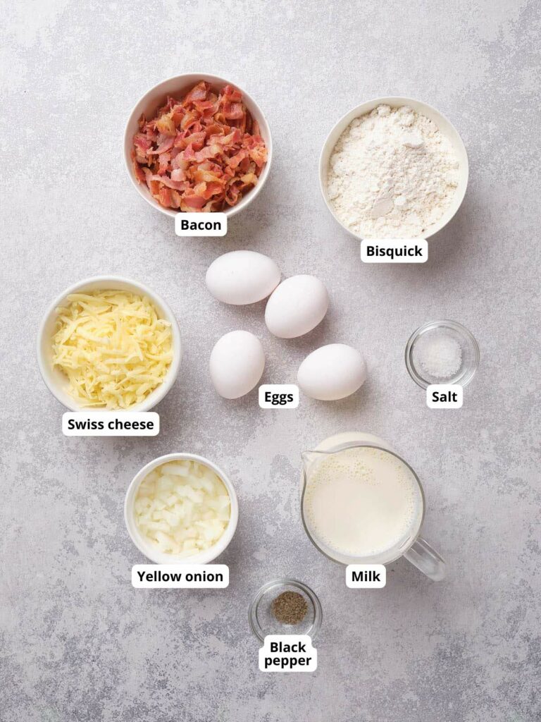 Ingredients for impossible quiche arranged on a textured surface.