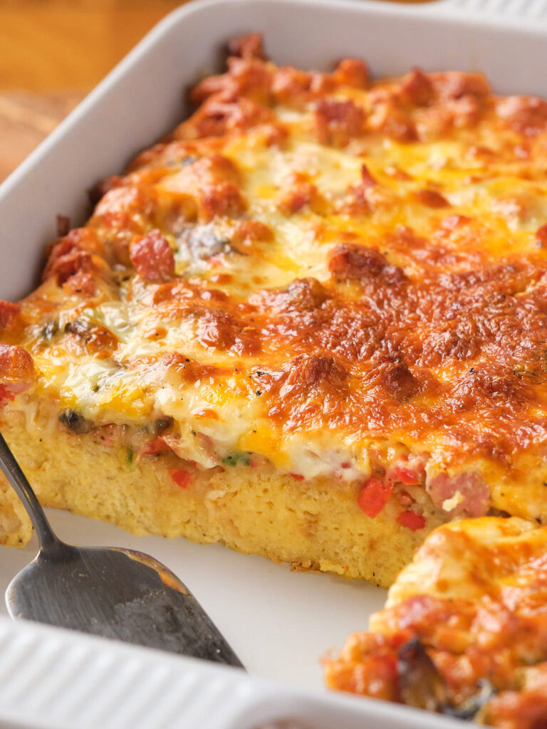 A casserole dish with a cheesy breakfast casserole.