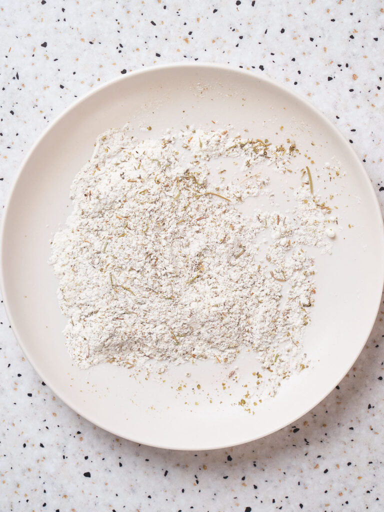 A white plate containing flour.