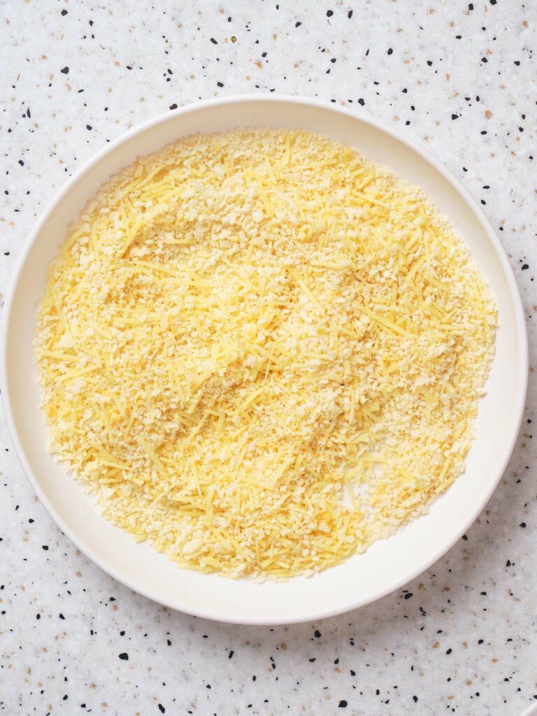 A combination of bread crumbs and flour on a white plate.