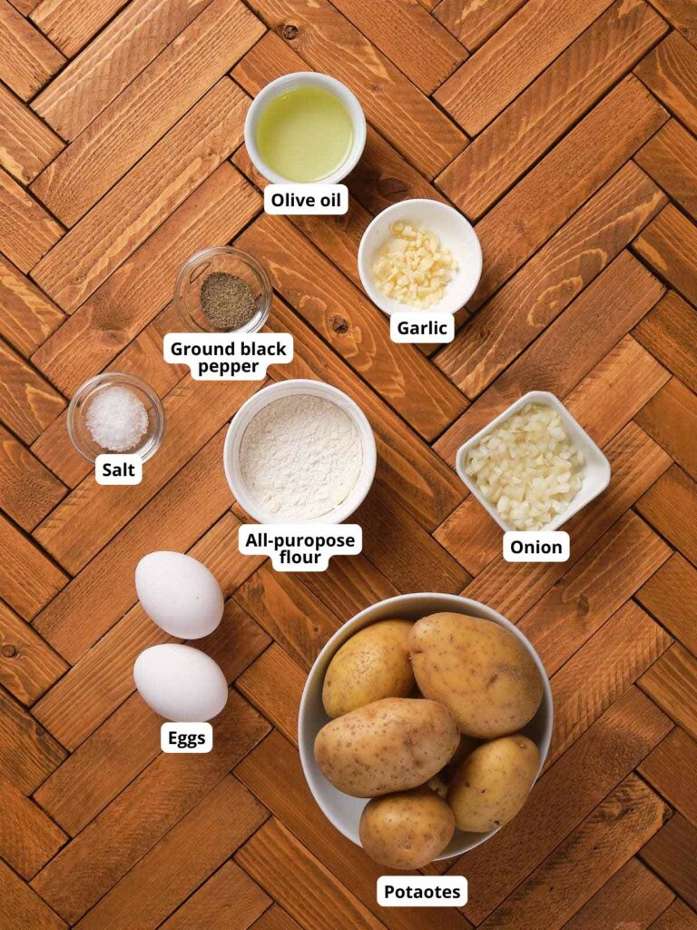 Ingredients for potato fritters on a wooden background.