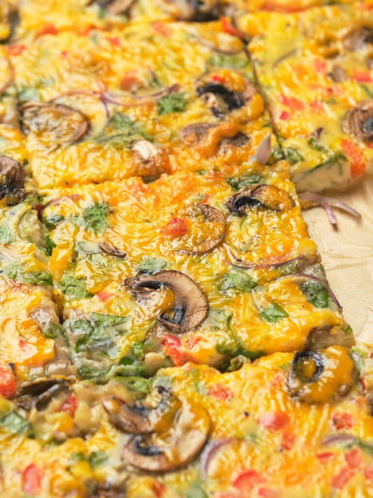 Close-up of sheet pan eggs on a wooden surface.