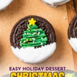 Decorated Oreo cookies with green icing shaped like Christmas trees, topped with a yellow star and colorful sprinkles.