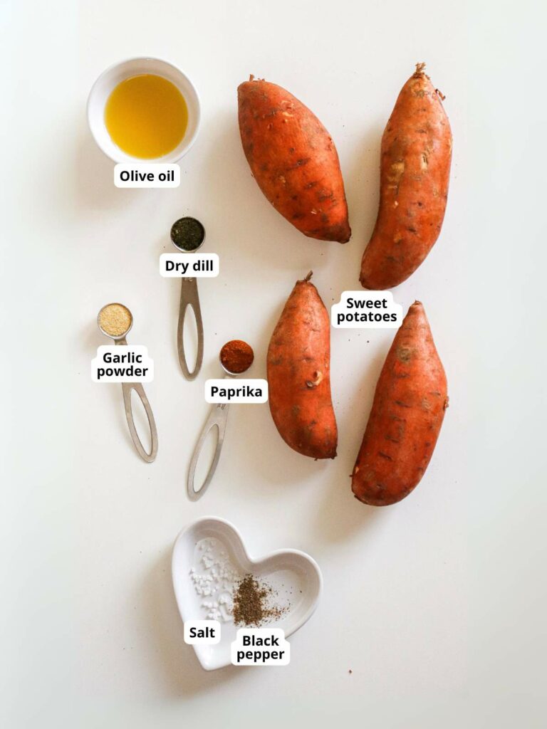 Ingredients for sweet potato fries arranged on a white surface.