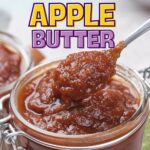 A spoon scooping apple butter from a glass jar, with "Easy Slow Cooker Apple Butter" written above.