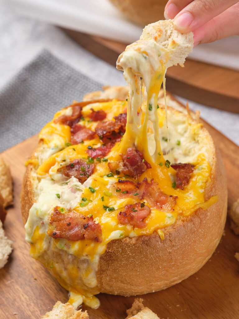 Cheese and bacon cob loaf filled with cheesy dip topped with bacon and chives.