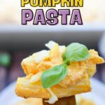 A fork holding pumpkin pasta with cheese and basil garnish. Text reads "Cozy Comfort Pumpkin Pasta.