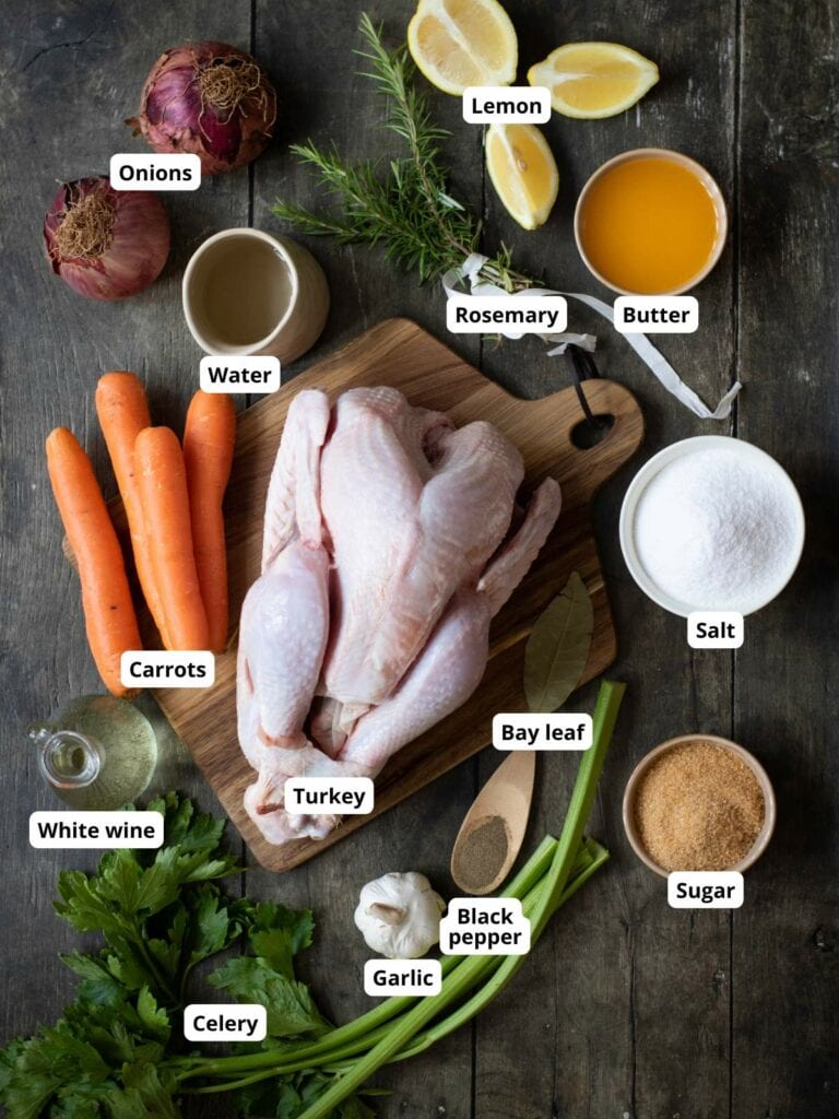 Ingredients for roasted turkey on a wooden surface, each labeled.