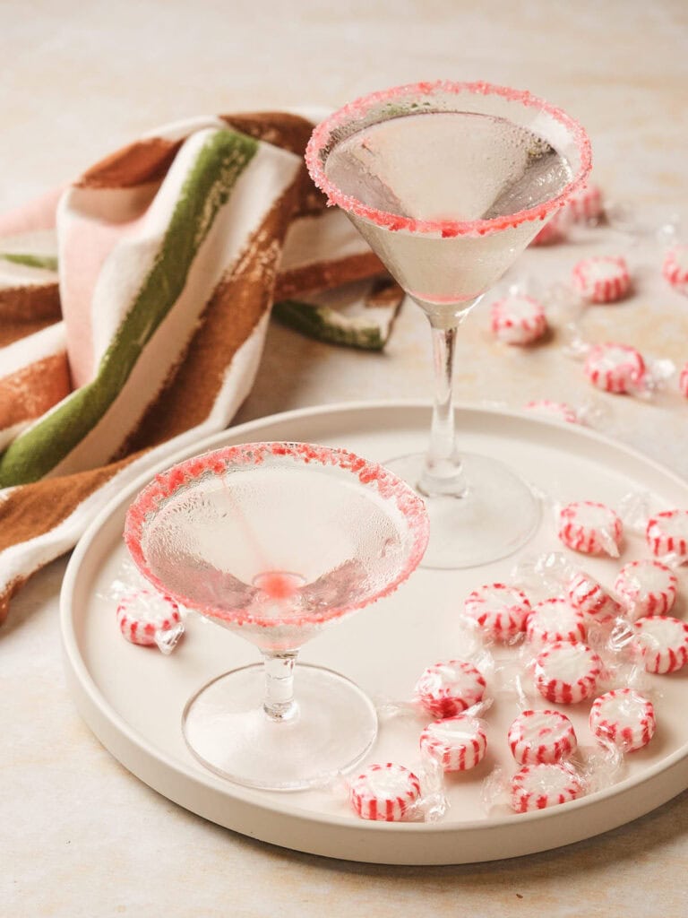 Two candy cane martini with sugar-rimmed edges.