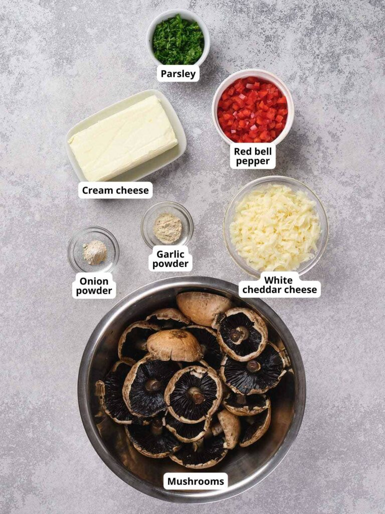 Ingredients for stuffed mushrooms arranged on a surface.