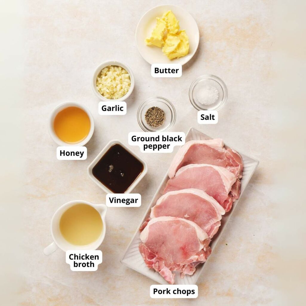 Top view of honey glazed pork chops ingredients on a light colored surface.