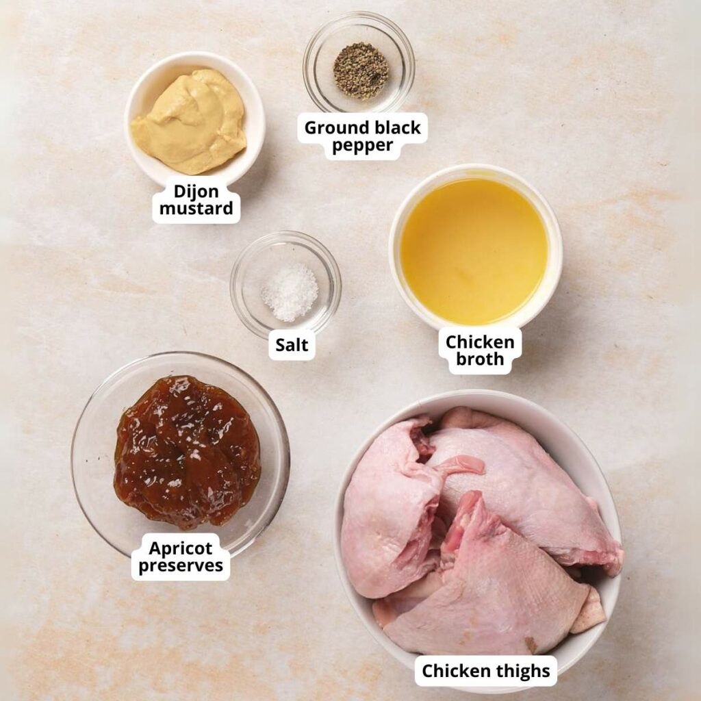 Ingredients for slow cooker apricot chicken on a light colored surface.