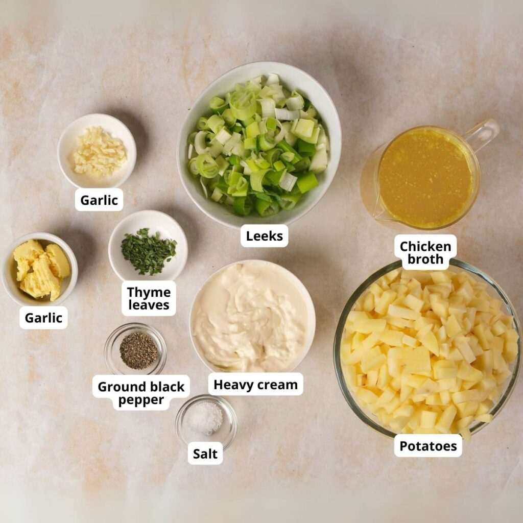 Ingredients for slow cooker potato and leek soup displayed in bowls on a light surface.