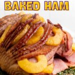 A baked ham garnished with pineapple slices and herbs is shown on a cutting board with the text “Juicy Pineapple Baked Ham” above it.