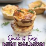 Two mini salmon quiches stacked on top of each other, garnished with herbs, with more quiches blurred in the background.