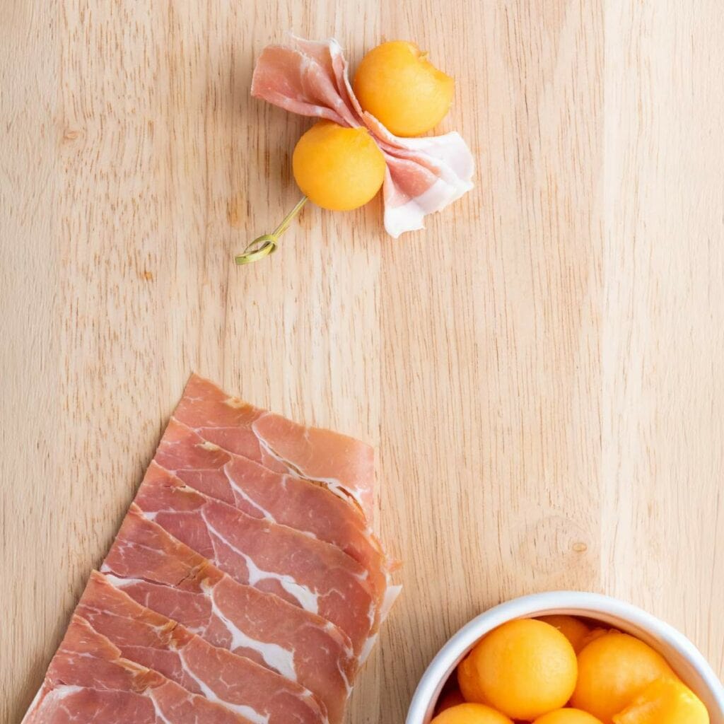A skewer with prosciutto and cantaloupe balls.