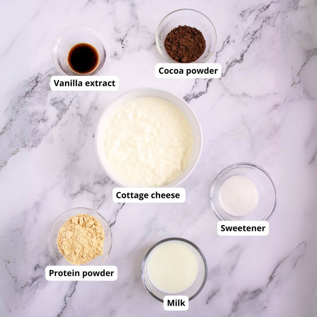 Six labeled bowls on a marble surface containing ingredients.