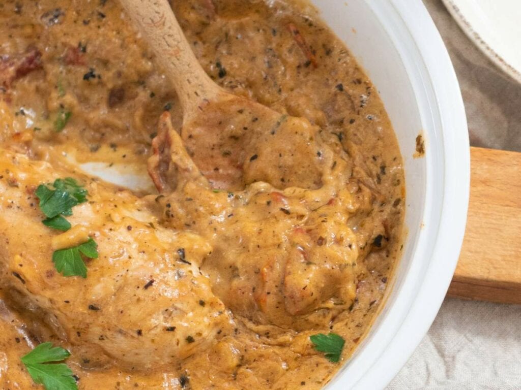 Marry me chicken skillet, herb-seasoned sauce, garnished with parsley.