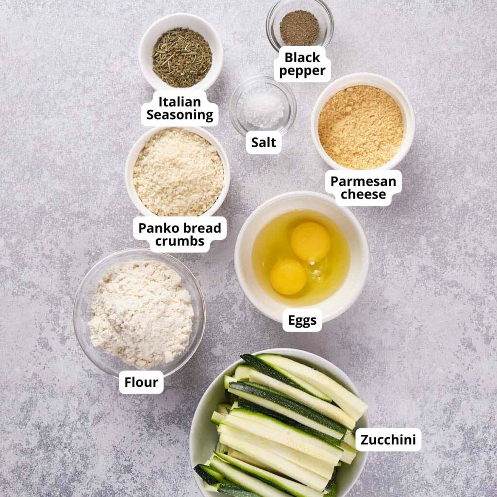 Bowls with labeled ingredients are arranged on a gray surface.