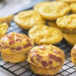 Baked muffins featuring visible slices of ham offer a savory, handheld breakfast option.