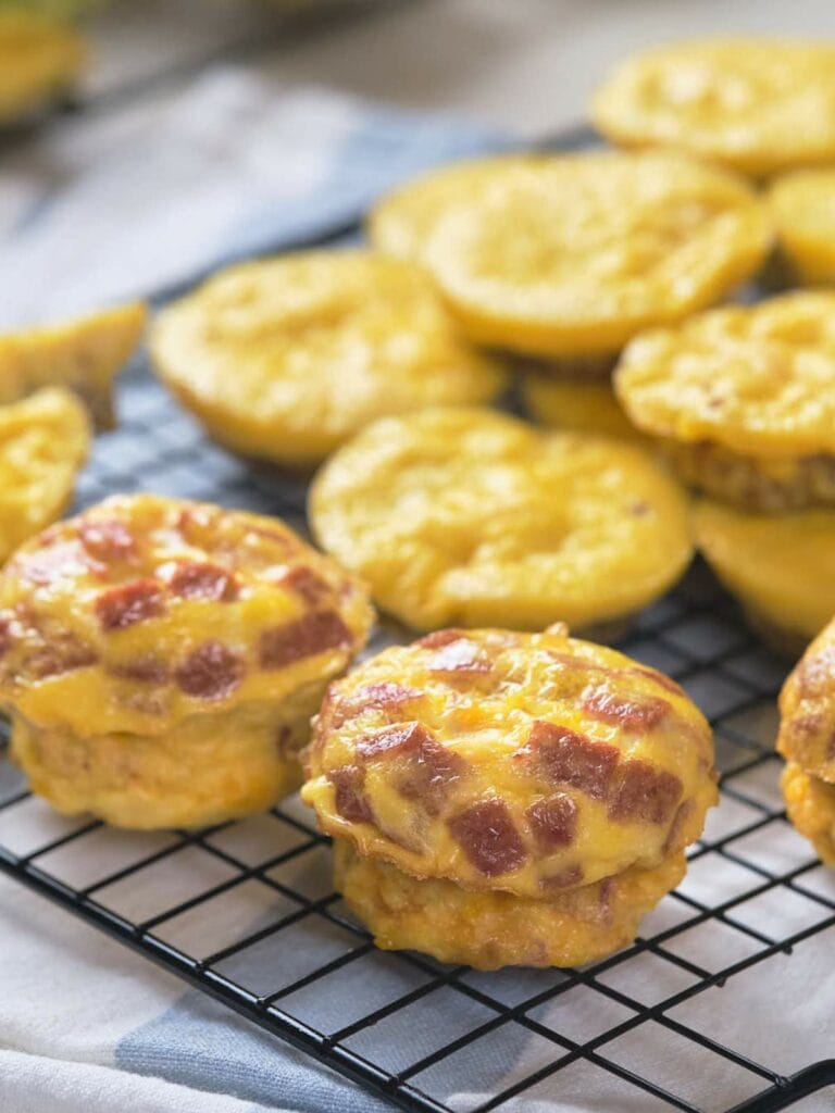 Baked muffins featuring visible slices of ham offer a savory, handheld breakfast option.
