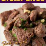 Close-up of juicy garlic butter steak bites garnished with herbs from quickpreprecipes.com.