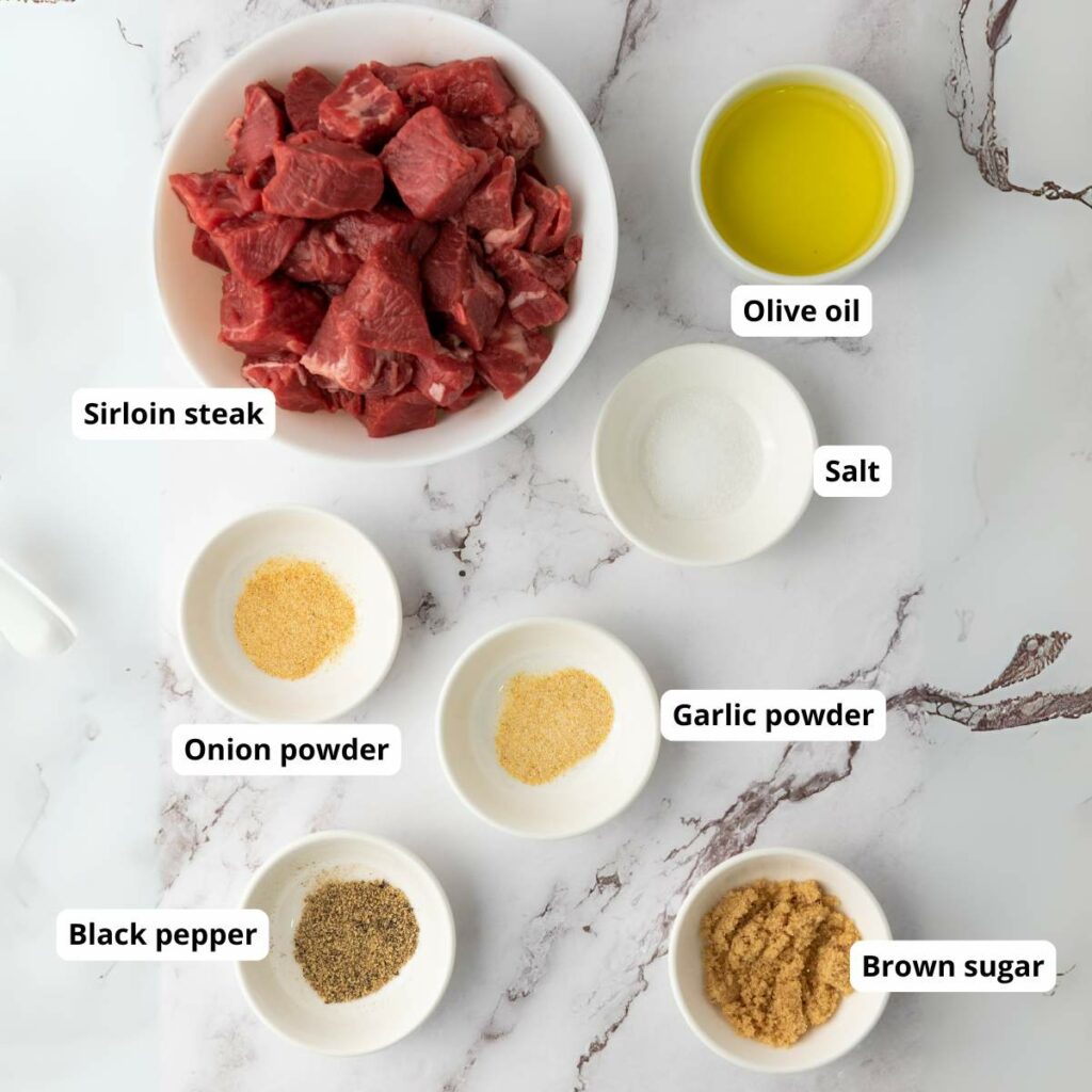 Ingredients for garlic butter steak bites are laid out and labeled for cooking.