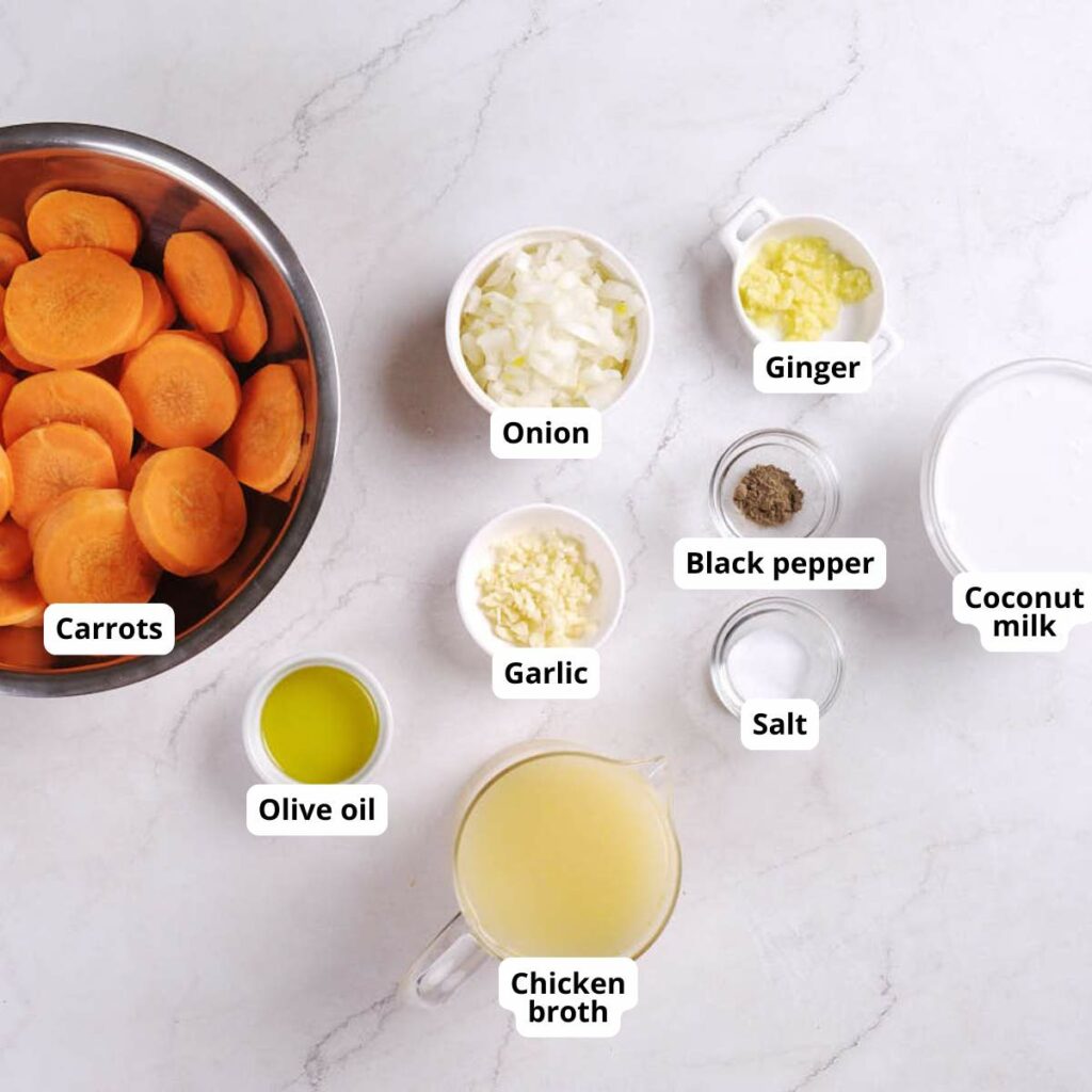 A top-down view of bowls containing instant pot carrot ginger soup recipe on a white surface.
