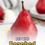 A red wine poached pear served on a white plate with a scoop of ice cream.