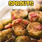 Close-up of roasted Brussels sprouts with pieces of bacon on a white plate.