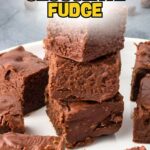 A plate of stacked chocolate fudge squares.